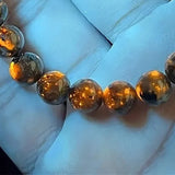 Ember Bracelet glowing orange under 365nm UV light