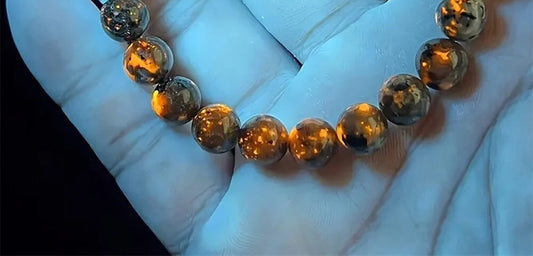 Ember Bracelet glowing orange under 365nm UV light